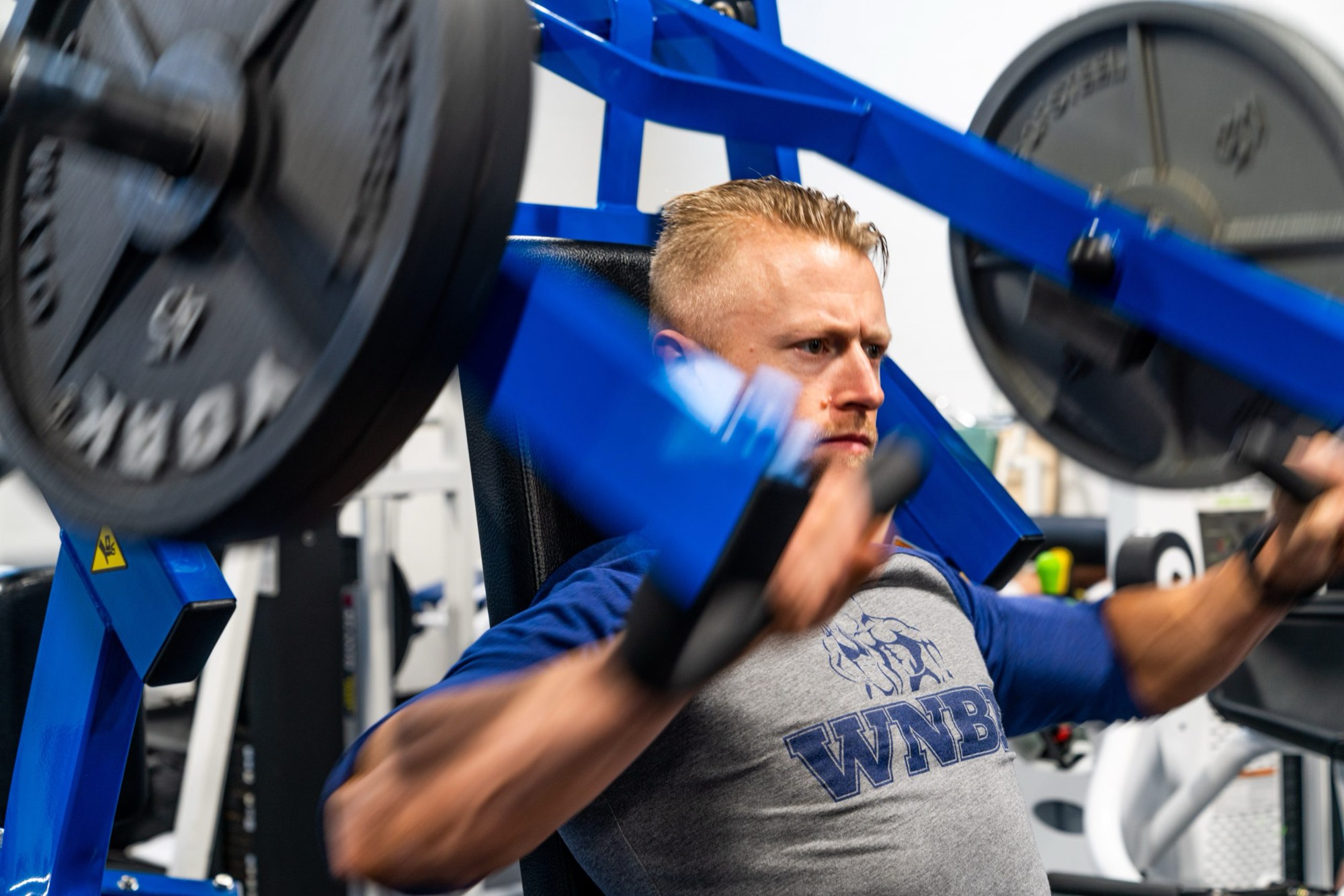 A Kings member training in a WNBF natural bodybuilding shirt